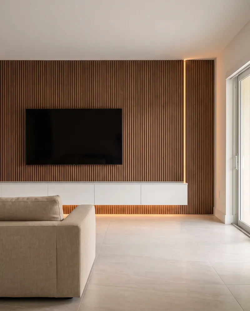 Walnut-finish TV wall with a vertical warm LED line