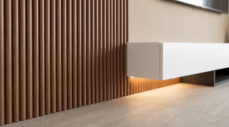 Close-up of walnut-finish fluted panels with warm LED under a floating console