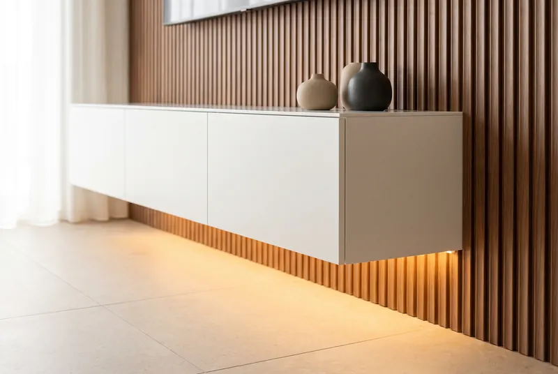 White floating console with warm LED glowing underneath